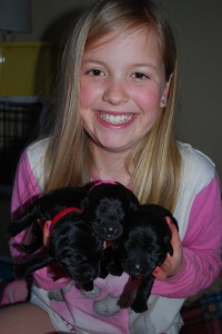 Katherine with the three black girl pups